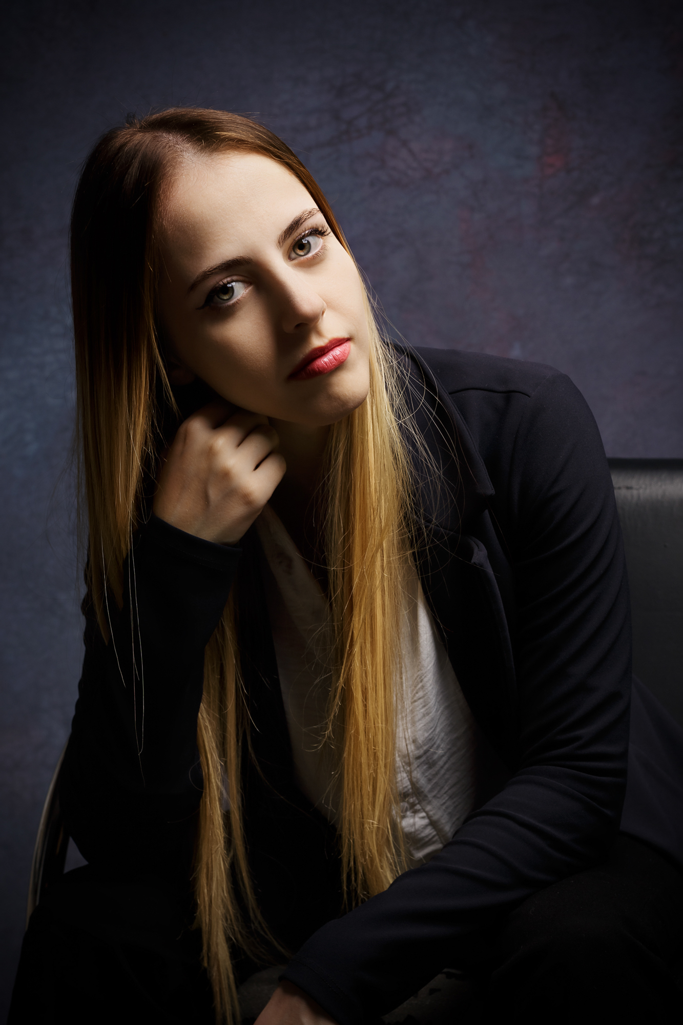 Retrato editorial feminino com maquiagem marcante e iluminação dramática